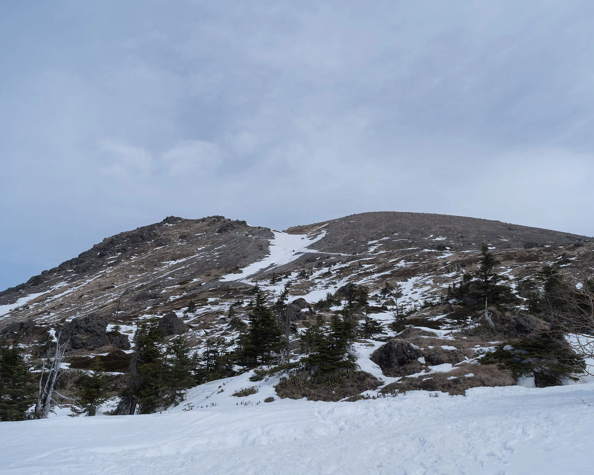 雪原の向こうに見上げる日光白根山の山体。標高2,578mの威風堂々とした冬の佇まい。